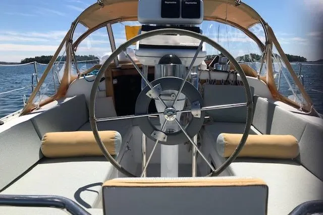 Slide: The Image of 1989 Freedom 38 Sloop sailboat cockpit with steering wheel, on a sunny day at sea. - 66