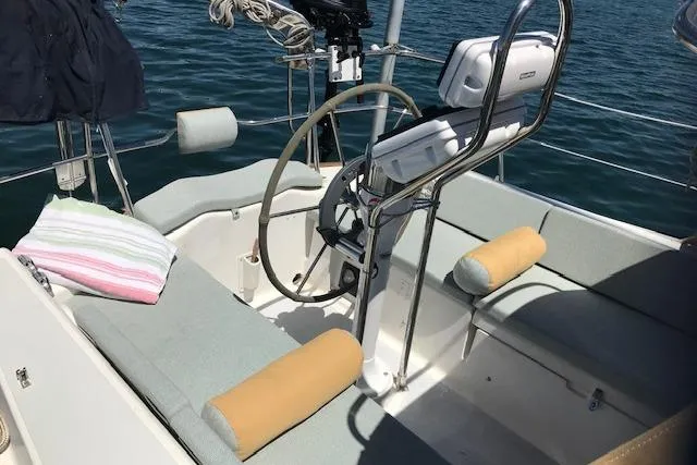 Slide: The Image of Cockpit of 1989 Freedom 38 Sloop with steering wheel and cushioned seating. - 67
