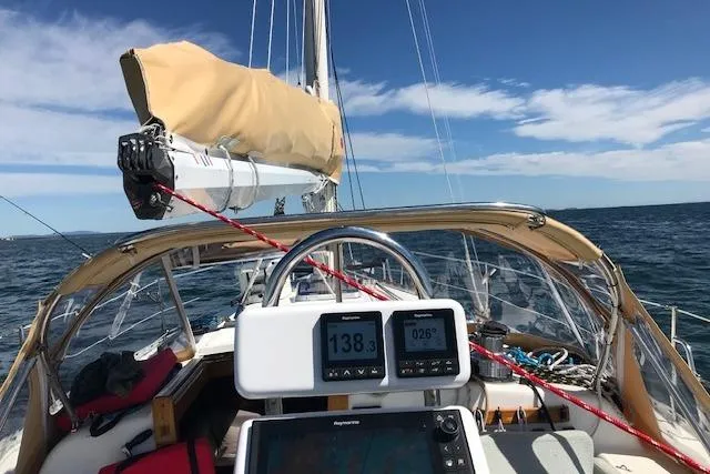 Slide: The Image of Sailing on a 1989 Freedom 38 Sloop with navigational instruments, open sea view. - 71