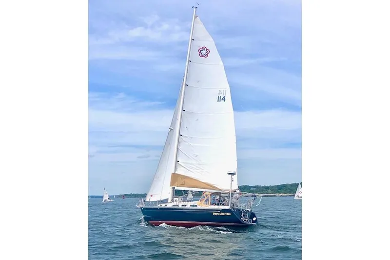 Slide: The Image of Sailing Freedom 38 Sloop, 1989 model, on open water under clear skies. - 72