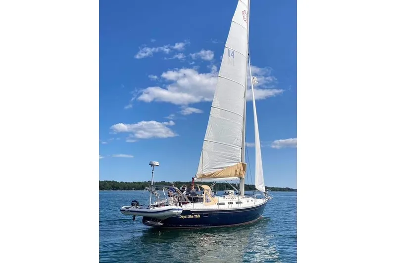 Slide: The Image of 1989 Freedom 38 Sloop sailing on a clear blue lake under a sunny sky. - 73