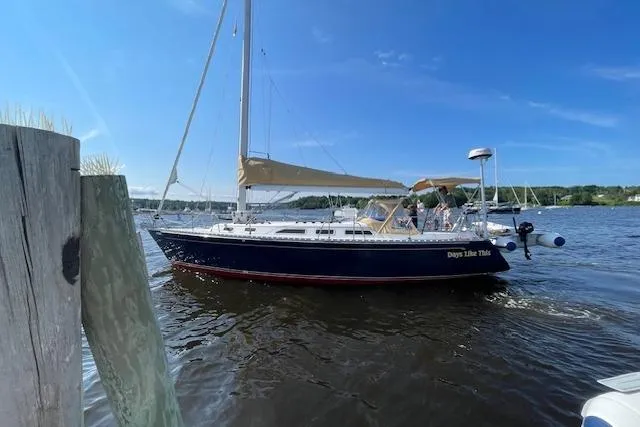 Slide: The Image of 1989 Freedom 38 Sloop sailing on a sunny day, with clear blue skies and calm waters. - 74