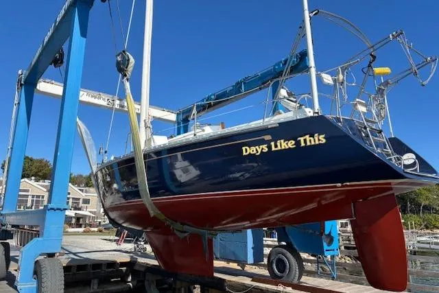 Slide: The Image of 1989 Freedom 38 Sloop sailboat "Days Like This" on a boat lift at a marina. - 75