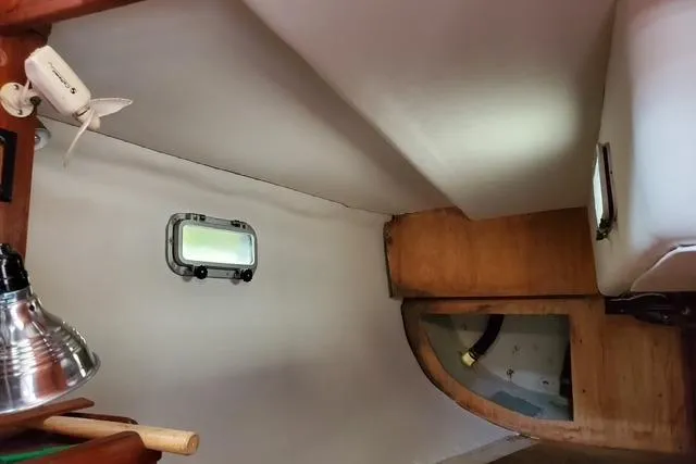 Slide: The Image of Interior of 1989 Freedom 38 Sloop sailboat, featuring wooden and white paneling. - 8