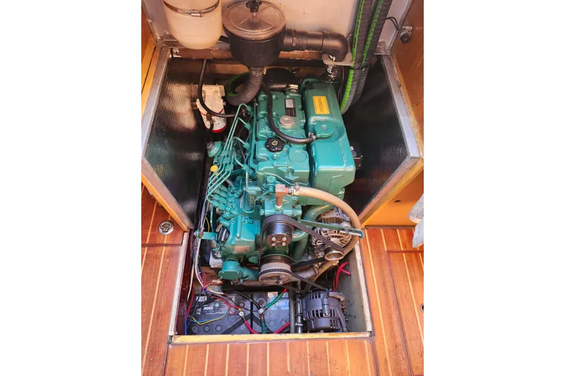 Slide: The Image of Engine compartment of a 1987 Custom Weld Exploration boat, showcasing detailed mechanical components. - 11