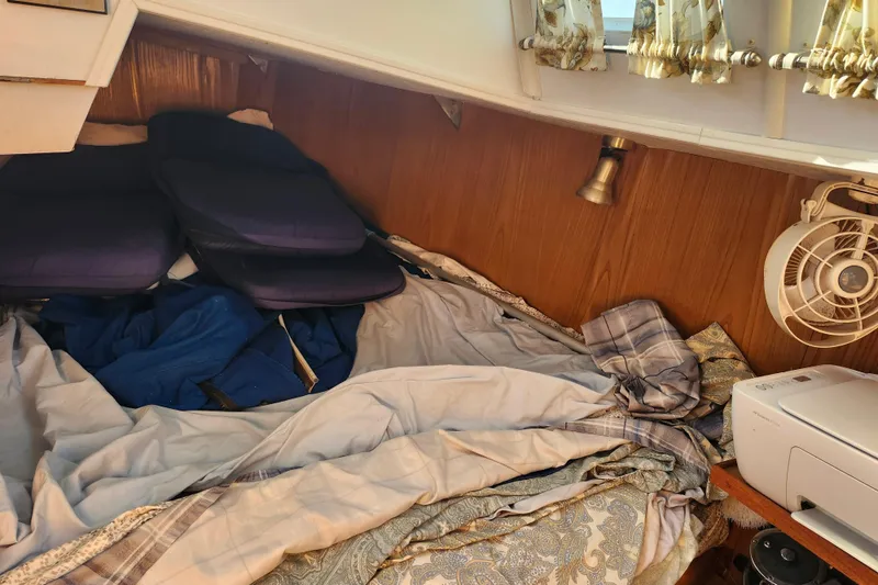 Slide: The Image of Cozy cabin interior of 1987 Custom Weld Exploration boat with bedding and fan. - 13