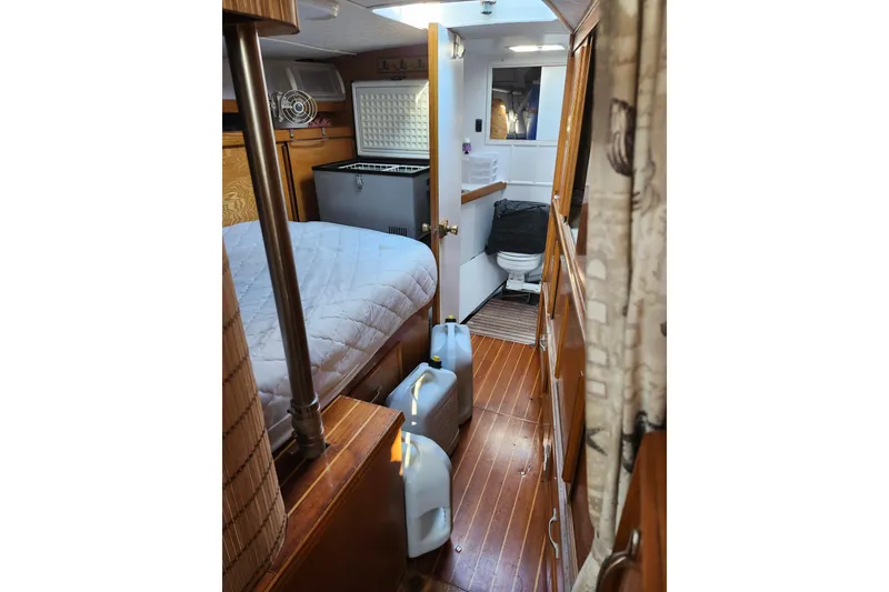 Slide: The Image of Interior of 1987 Custom Weld Exploration boat with bed, fridge, and bathroom. - 14