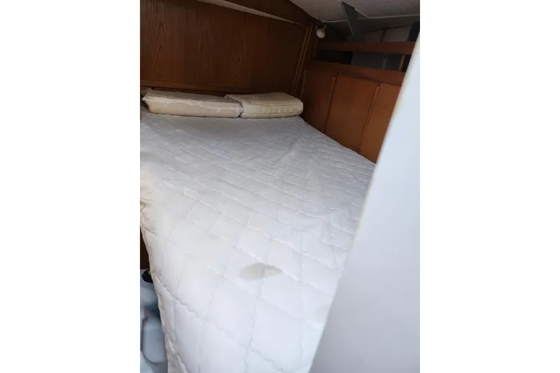 Slide: The Image of Interior cabin bed of 1987 Custom Weld Exploration boat with quilted mattress. - 18