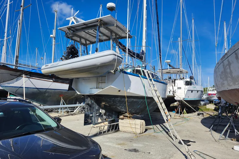 Slide: The Image of Boatyard scene with 1987 Custom Weld Exploration sailboat under maintenance, surrounded by other vessels. - 22