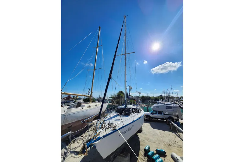 Slide: The Image of 1987 Custom Weld Exploration sailboat docked under clear blue sky. - 32