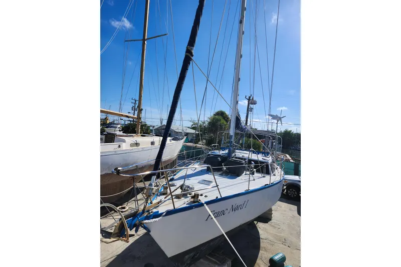 Slide: The Image of 1987 Custom Weld Exploration sailboat docked under clear blue sky. - 33