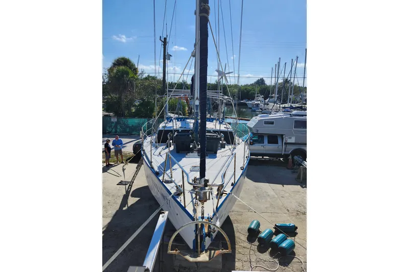 Slide: The Image of 1987 Custom Weld Exploration sailboat docked, with masts and equipment visible. - 36