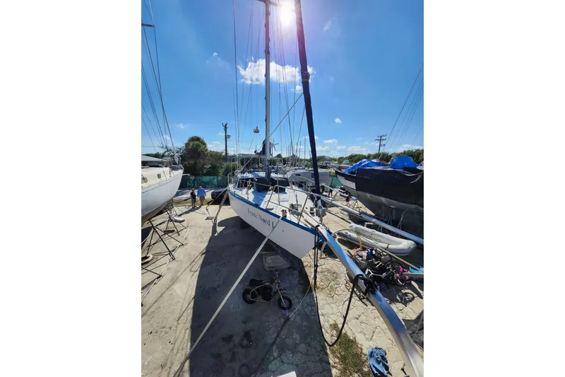 Slide: The Image of 1987 Custom Weld Exploration sailboat in dry dock under clear blue sky. - 37