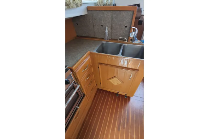 Slide: The Image of 1987 Custom Weld Exploration boat kitchen with wooden cabinets and dual stainless steel sinks. - 38