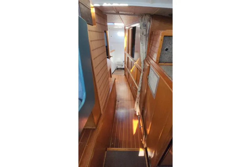 Slide: The Image of Interior of 1987 Custom Weld Exploration boat with wooden paneling and narrow hallway. - 39