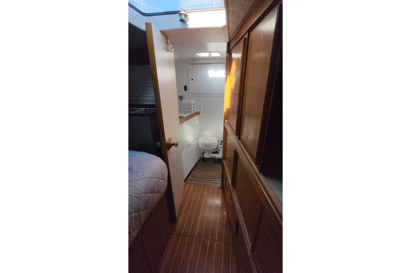 Slide: The Image of Interior of 1987 Custom Weld Exploration boat showing bathroom and wooden cabinetry. - 40