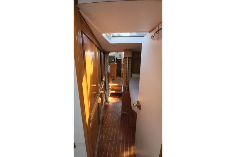 Slide: The Image of Interior view of 1987 Custom Weld Exploration boat with wooden flooring and natural light. - 41