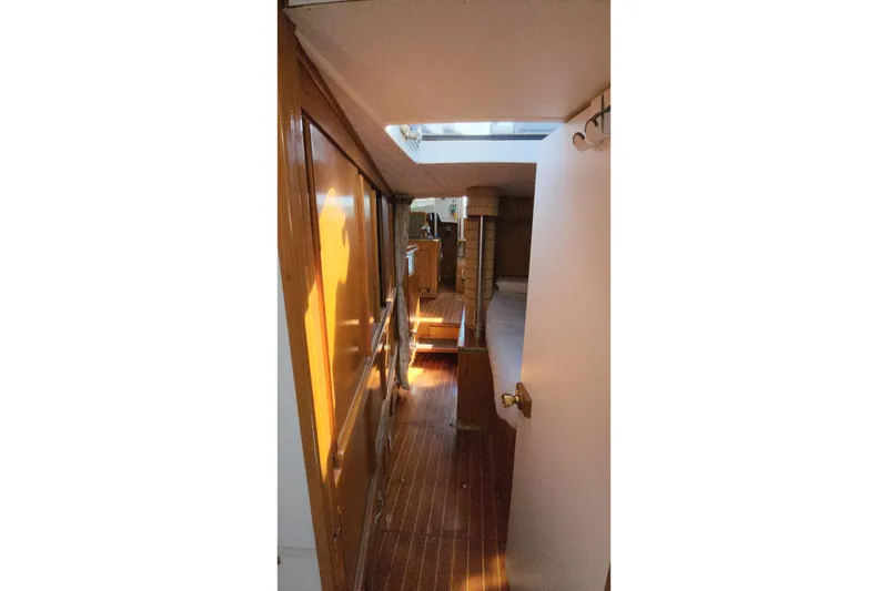 Slide: The Image of Interior view of 1987 Custom Weld Exploration boat with wooden finishes and natural lighting. - 42