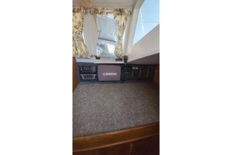 Slide: The Image of Control panel of a 1987 Custom Weld Exploration boat with Garmin equipment. - 44