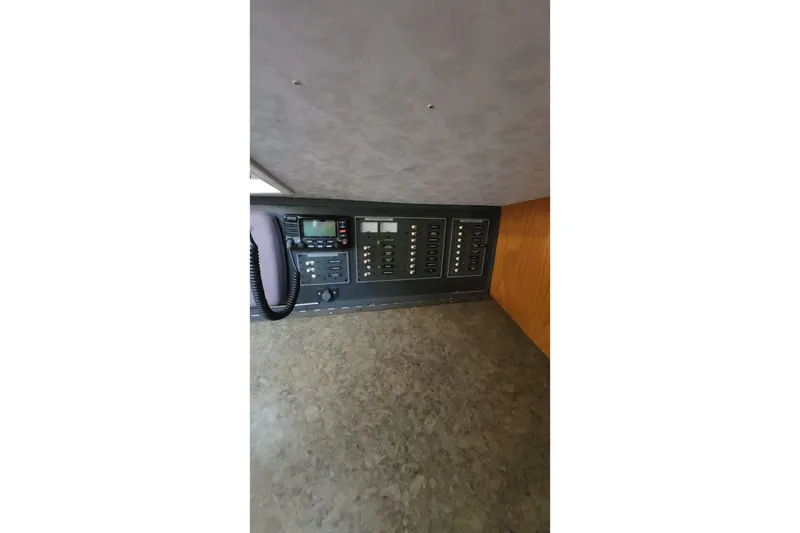 Slide: The Image of Control panel of a 1987 Custom Weld Exploration boat with radio and switches. - 45