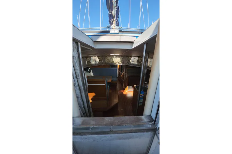 Slide: The Image of Interior view of 1987 Custom Weld Exploration boat, showcasing wooden seating and nautical design. - 46