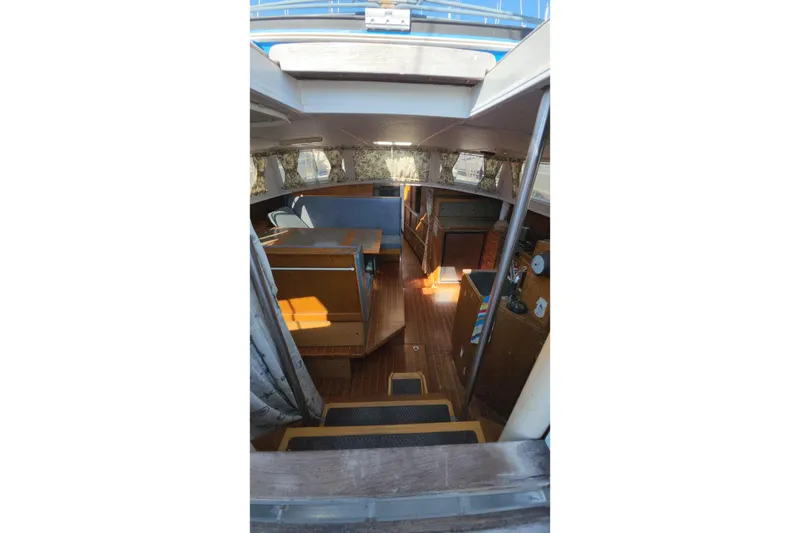 Slide: The Image of Interior of 1987 Custom Weld Exploration boat with wooden furnishings and seating area. - 48