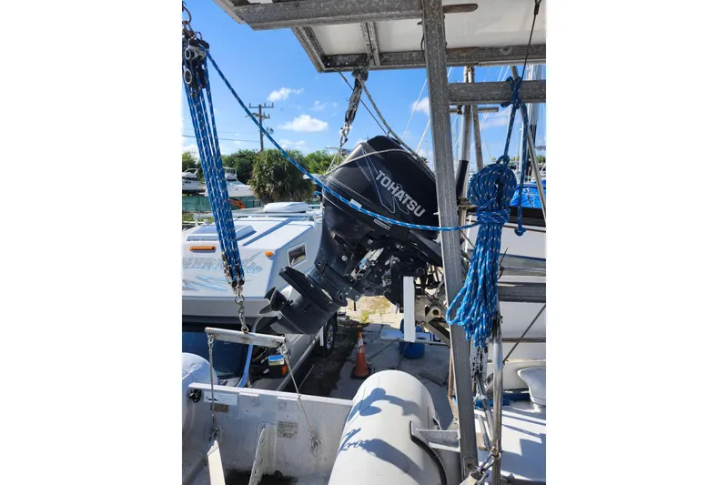 Slide: The Image of Outboard motor on a 1987 Custom Weld Exploration boat, docked with blue ropes. - 7