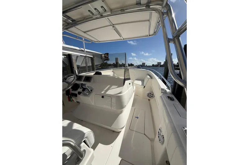 Slide: The Image of 2010 Intrepid 323 Cuddy boat interior with helm, seating, and water view. - 10
