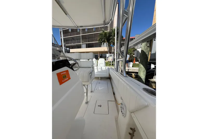 Slide: The Image of 2010 Intrepid 323 Cuddy boat interior with white seating and steering wheel. - 15