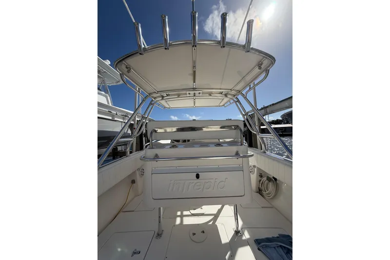 Slide: The Image of 2010 Intrepid 323 Cuddy boat interior with seating and overhead canopy. - 8