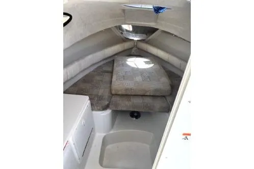 Slide: The Image of 2006 Seaswirl Striper 2601 Walkaround O/B cabin interior with cushioned seating. - 10