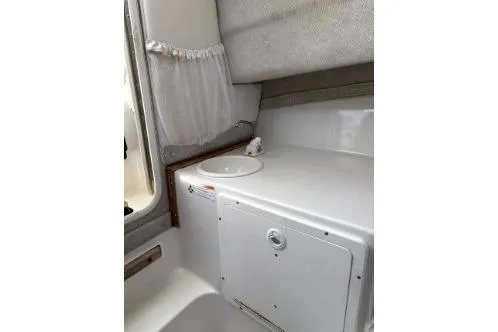 Slide: The Image of 2006 Seaswirl Striper 2601 Walkaround O/B cabin interior with sink and storage. - 11