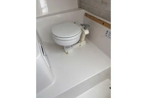 Slide: The Image of 2006 Seaswirl Striper 2601 Walkaround O/B boat toilet area, white interior. - 12