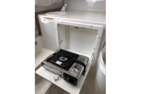 Slide: The Image of 2006 Seaswirl Striper 2601 Walkaround O/B boat interior with built-in stove. - 13