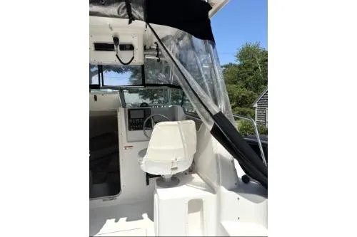 Slide: The Image of 2006 Seaswirl Striper 2601 Walkaround O/B boat interior with captain's chair and dashboard. - 6