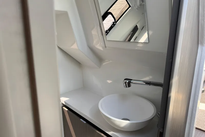 Slide: The Image of 2024 Jeanneau NC 895 Series 2 bathroom with modern sink and mirror. - 14