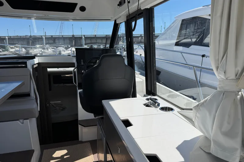 Slide: The Image of Interior view of 2024 Jeanneau NC 895 Series 2 boat, featuring helm and seating area. - 4