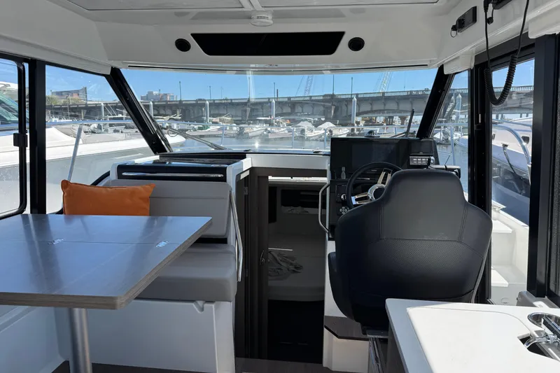 Slide: The Image of Interior of 2024 Jeanneau NC 895 Series 2 boat, featuring helm and seating area. - 5