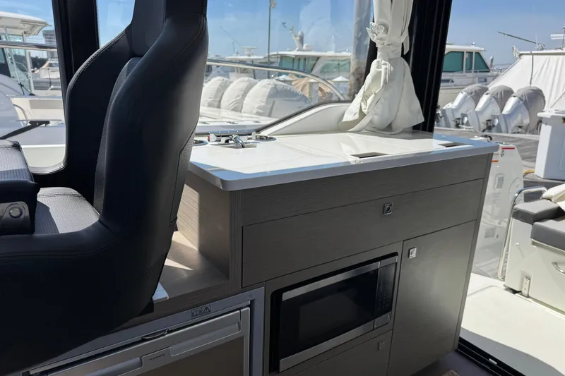 Slide: The Image of Interior of 2024 Jeanneau NC 895 Series 2 boat with seating and kitchenette. - 6