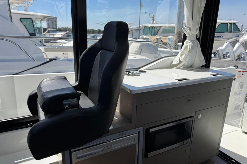 Slide: The Image of 2024 Jeanneau NC 895 Series 2 interior helm with modern seating and controls. - 7