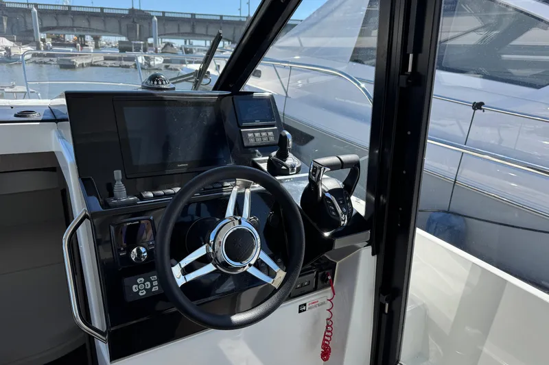 Slide: The Image of 2024 Jeanneau NC 895 Series 2 helm with modern controls and navigation system. - 8
