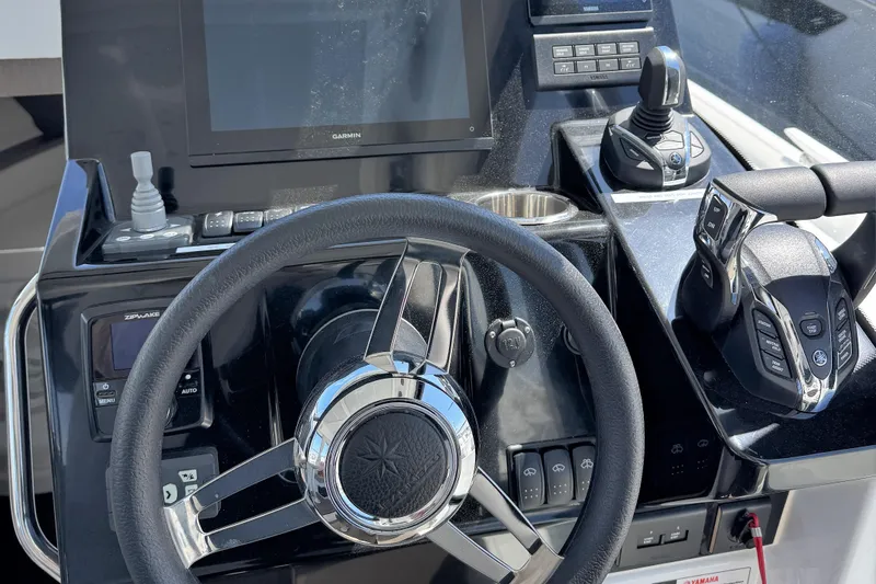 Slide: The Image of Steering console of 2024 Jeanneau NC 895 Series 2 with advanced controls and Garmin display. - 9