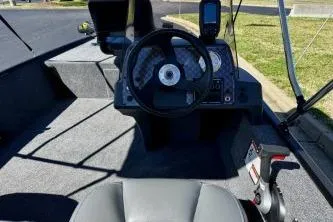 Slide: The Image of 2025 Tracker Bass Tracker Classic XL boat interior with steering wheel and dashboard controls. - 6