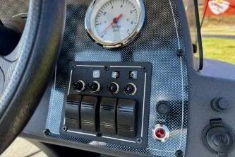 Slide: The Image of 2025 Tracker Bass Tracker Classic XL dashboard with switches and gauge. - 8