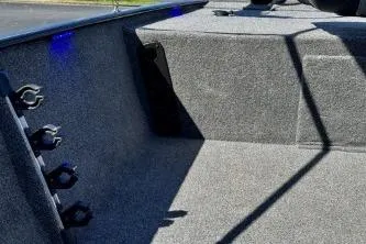 Slide: The Image of 2025 Tracker Bass Tracker Classic XL interior with carpeted flooring and rod holders. - 9