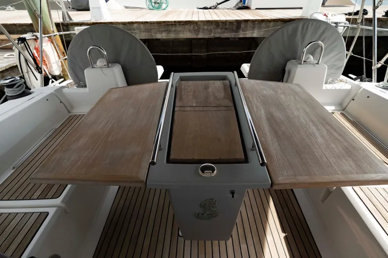 Slide: The Image of 2017 Beneteau Oceanis 41.1 cockpit with wooden table and seating area. - 10