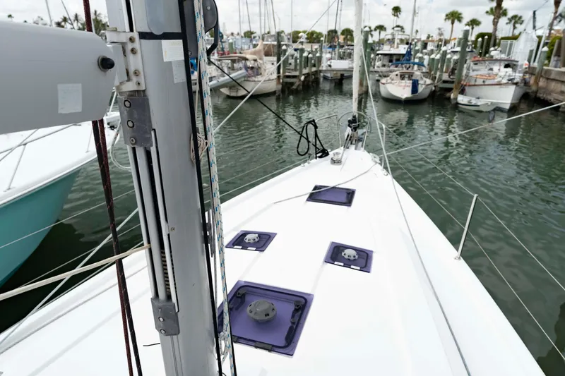 Slide: The Image of 2017 Beneteau Oceanis 41.1 sailboat docked in a marina, showcasing deck and mast. - 17