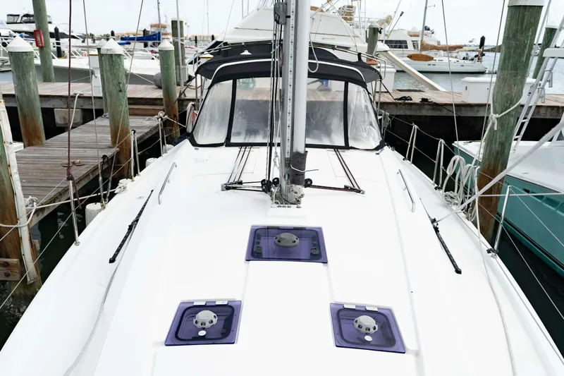Slide: The Image of 2017 Beneteau Oceanis 41.1 sailboat docked at a marina, showcasing its sleek deck design. - 21