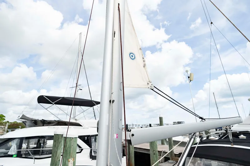 Slide: The Image of 2017 Beneteau Oceanis 41.1 sailboat docked, mast and boom visible under cloudy sky. - 22