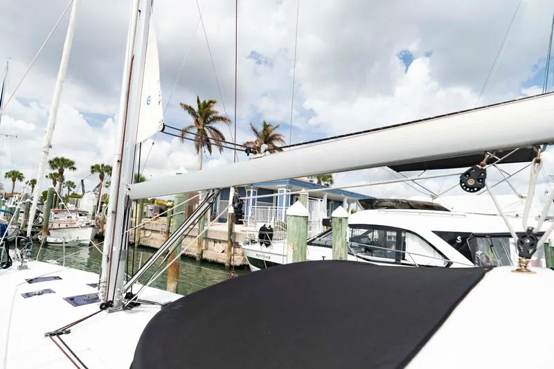 Slide: The Image of 2017 Beneteau Oceanis 41.1 sailboat docked at a marina with palm trees. - 24